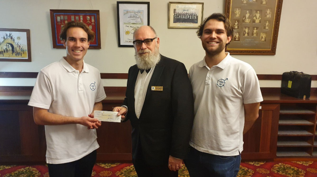Old Gold Cheque three men holding a cheque for $1000 for charity