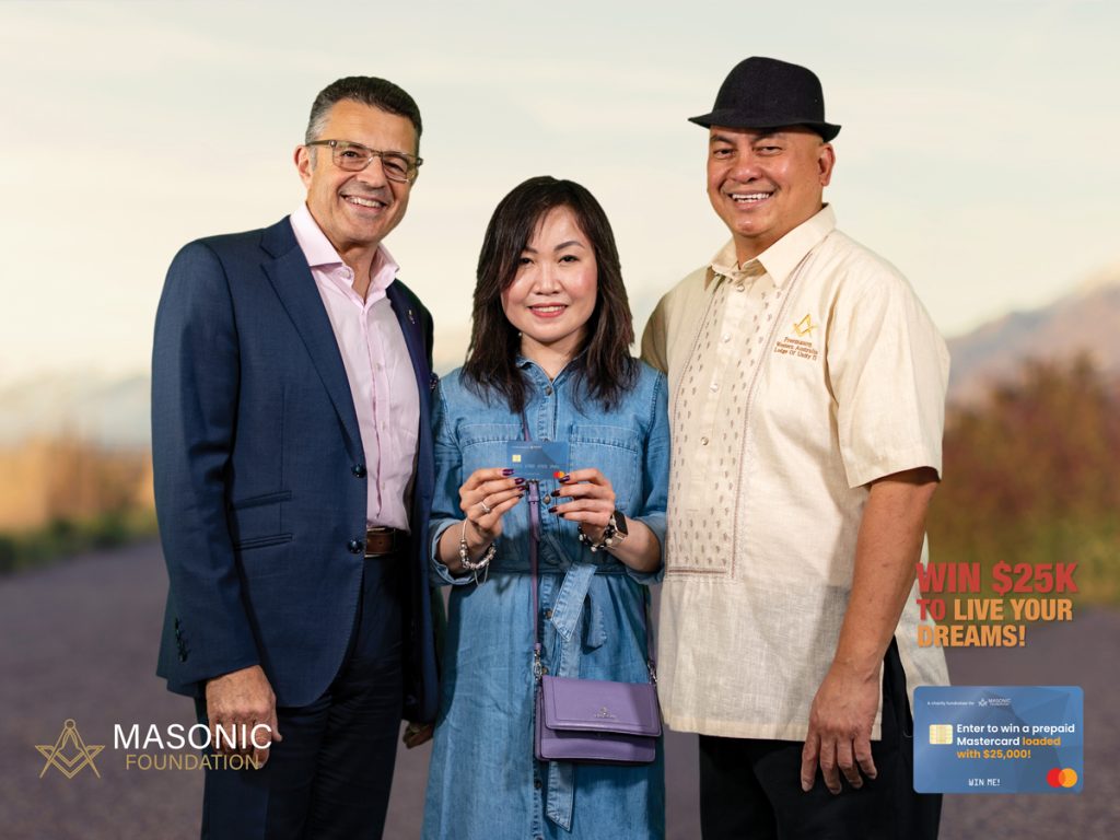 Two men and a woman holding credit card prize